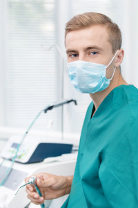 Young dentist in mask